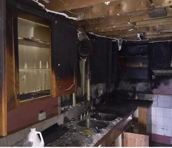 kitchen with burnt cabinets from fire 