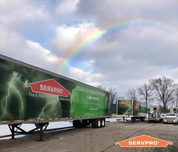 Helping to Make the best out of any Fire or Water Disaster - Image of SERVPRO vehicles beneath a rainbow
