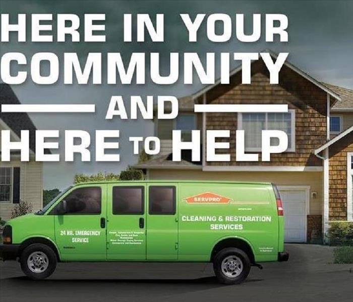 A SERVPRO vehicle with a message that says here in your community and here to help
